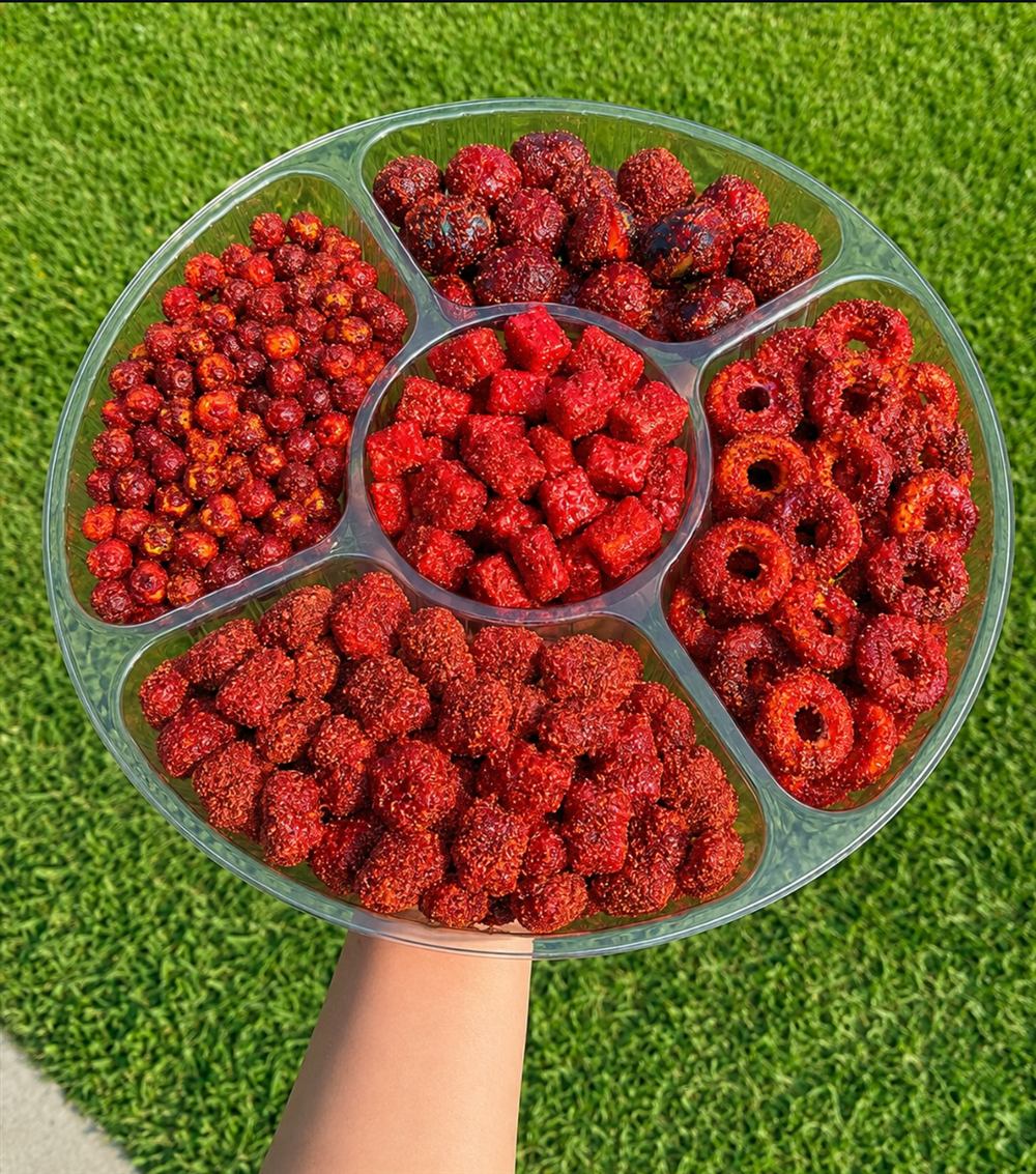Variety tray of dulces enchilados: strawberries, mandarinas, and peach rings